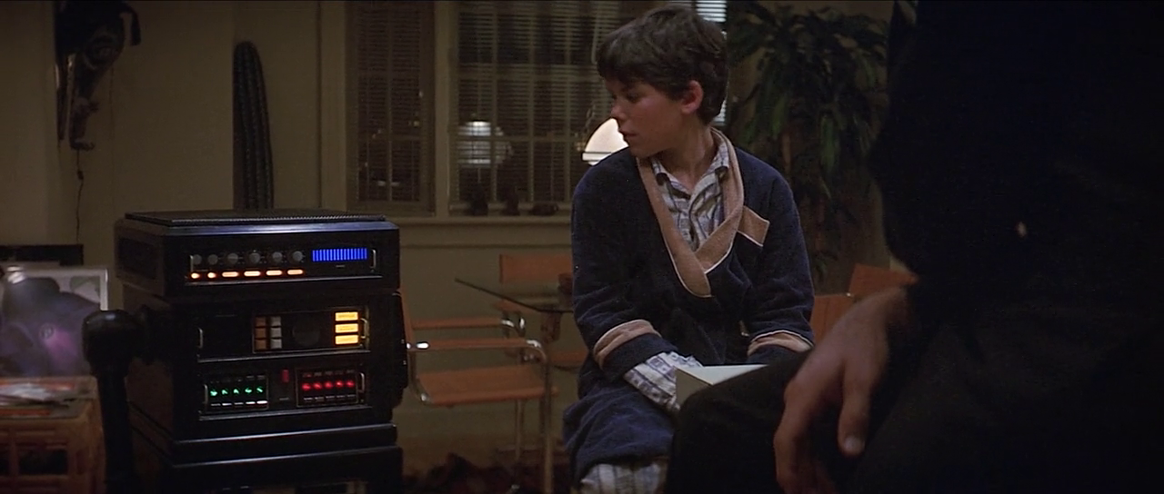 Child talking to robot. Still from movie Runaway (1984)